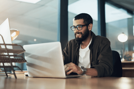 Man on laptop, smiling