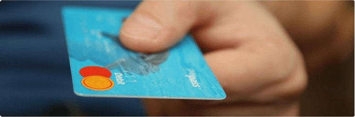 man holding out credit card