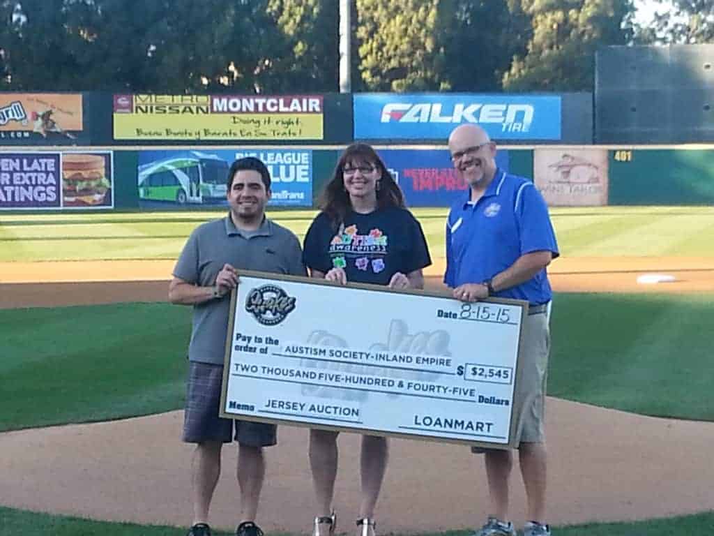 Missak Tokhmanian from LoanMart awarding a check to Beth Burt, president of the Autism Society Inland Empire (ASIE)