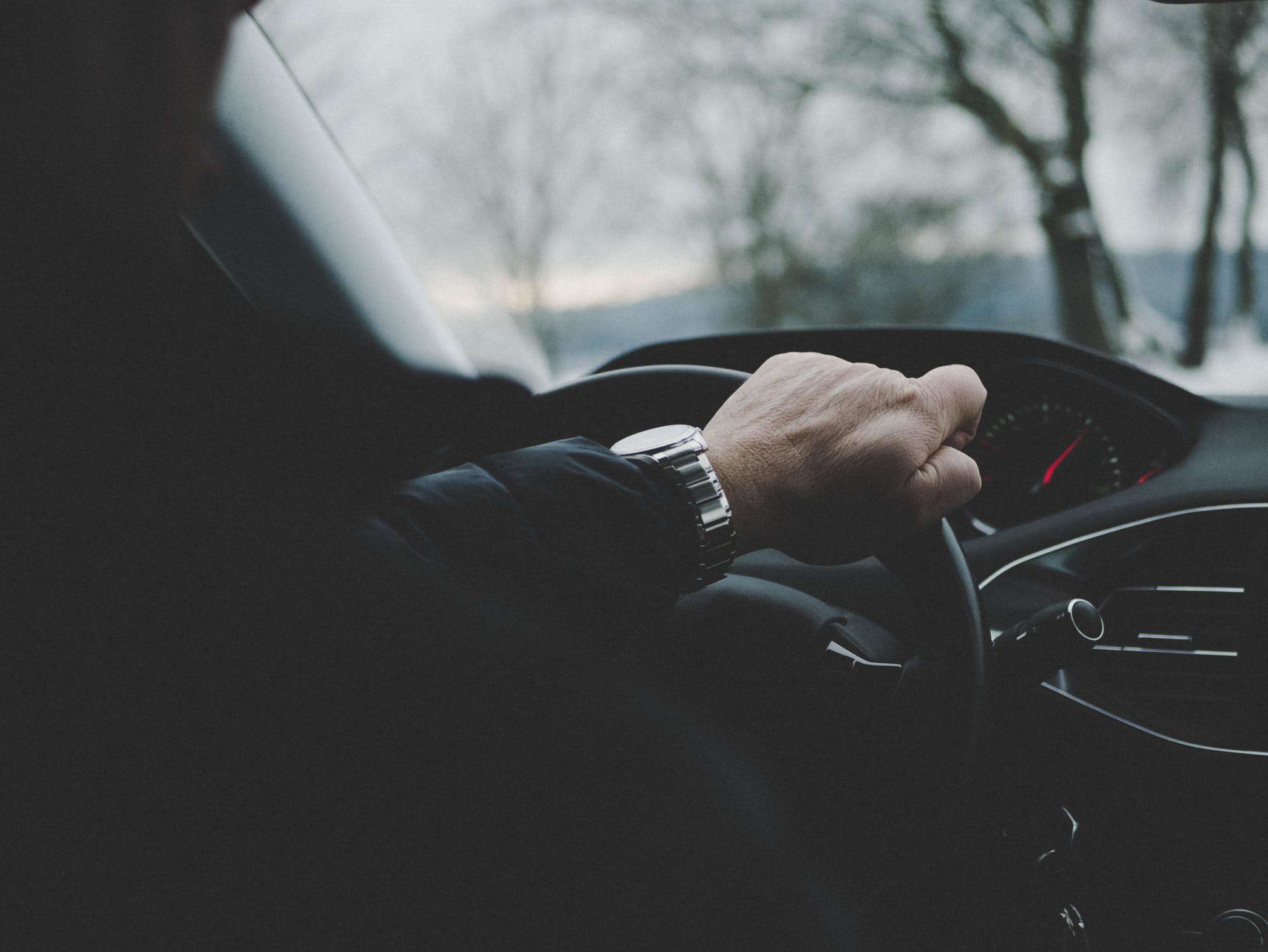 business man inside title loan vehicle
