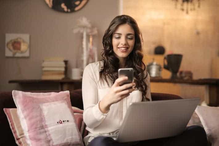 woman on phone and laptop