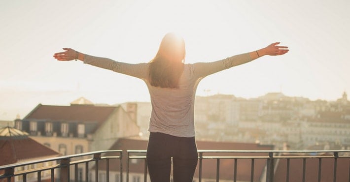 woman arms out on balcony