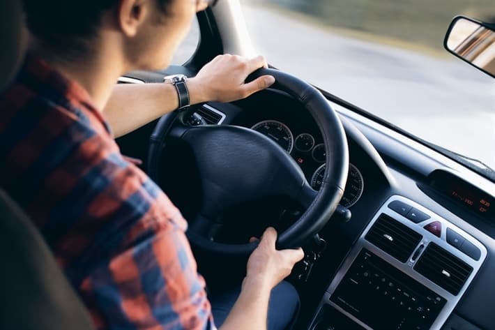 man driving car for title loan