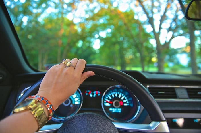 Woman's hand on a steering wheel