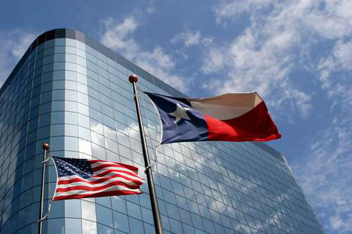 Texas flag flying in front of a courthouse representing state title loan laws and compliance